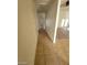 Long hallway with tile flooring and access to bedrooms at 3640 Judson Ave, Las Vegas, NV 89115