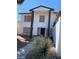 Two-story house with columns, neutral color scheme, and landscaping at 5243 Sunnywood Dr, Las Vegas, NV 89120