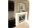 Modern fireplace with white mantel and glass screen at 6030 Halehaven Dr, Las Vegas, NV 89110