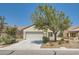 Single-story home with attached garage and landscaping at 2220 Carrier Dove Way, North Las Vegas, NV 89084