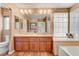 Bathroom with double vanity, soaking tub, and glass block window at 4156 Balmoral Castle Ct, Las Vegas, NV 89141