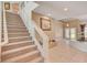 Grand staircase with glass railing leading to upper floor at 4156 Balmoral Castle Ct, Las Vegas, NV 89141