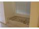 Elegant bathtub with jets and marble surround at 6687 Atwood Ave, Las Vegas, NV 89108