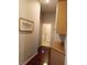 Light-filled hallway with wood floors, laundry access, and built-in cabinets at 1625 Pacific Tide Pl, Las Vegas, NV 89144