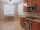 Kitchen with wood cabinets, stainless steel appliances and tile floors at 1625 Pacific Tide Pl, Las Vegas, NV 89144