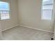 Well-lit bedroom featuring carpet and two windows at 9880 Angel Valley Dr, Las Vegas, NV 89178