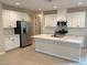 Modern kitchen with white cabinets, center island, and stainless steel appliances at 9880 Angel Valley Dr, Las Vegas, NV 89178