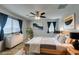 A Primary bedroom with a wooden bedframe, ceiling fan, and contemporary artwork at 6630 Evander St, North Las Vegas, NV 89086