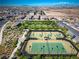 Aerial view of a community park with tennis and pickleball courts, a playground, and a covered picnic area at 723 Orange Plume Walk # 0, Henderson, NV 89011