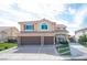 Two-story house with brown double doors and a two-car garage at 6611 Caddington Ave, Las Vegas, NV 89110