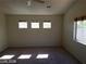 Bright bedroom featuring four windows and carpet at 7517 Apple Cider St, Las Vegas, NV 89131