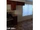 Kitchen with dark brown cabinets and a gas range at 1745 Starridge Way, Las Vegas, NV 89142