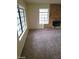 Living room with stone fireplace and large windows at 2813 Cacto Ct, Henderson, NV 89074