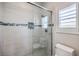 Clean bathroom with shower, toilet and window at 10537 Shoalhaven Dr, Las Vegas, NV 89134