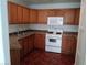 Full view of kitchen with wood cabinets and appliances at 1501 Linnbaker Ln # 103, Las Vegas, NV 89110