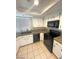 Bright kitchen features white cabinets, black appliances, and tile flooring at 2459 Domingo St, Las Vegas, NV 89121