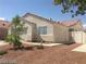 One-story house with a tan stucco exterior, tile roof, and a small front yard at 336 River Glider Ave, North Las Vegas, NV 89084