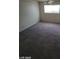 Bright bedroom featuring a large window and wall-to-wall carpet at 1710 Shadow Mountain Pl, Las Vegas, NV 89108