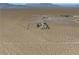 Aerial view of a desert property with a single-story house at 2441 Ottawa St, Sandy Valley, NV 89019