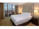 Spacious bedroom with a king-size bed and city views at 145 E Harmon Ave # 1120, Las Vegas, NV 89109