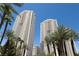 Luxury highrise building with palm trees and a clear blue sky at 145 E Harmon Ave # 1120, Las Vegas, NV 89109