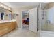 Bathroom with double sinks, shower, and view of bedroom at 679 Fontayne Ave, Las Vegas, NV 89123