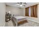 Well-lit bedroom, featuring a full-size bed and ceiling fan at 679 Fontayne Ave, Las Vegas, NV 89123