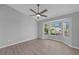 Bright bedroom with bay window, ceiling fan, and hardwood floors at 10024 Bundella Dr, Las Vegas, NV 89134