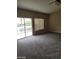 Bright bedroom with sliding glass doors and carpeting at 9758 Camino Capistrano Ln, Las Vegas, NV 89147