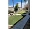 Backyard with putting green and stone bench at 9758 Camino Capistrano Ln, Las Vegas, NV 89147