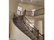 Elegant curved staircase with wrought iron railing at 9758 Camino Capistrano Ln, Las Vegas, NV 89147