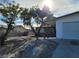 House exterior with a large tree and gravel driveway at 3955 Ventura Way, Las Vegas, NV 89121