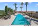 Community lap pool with palm trees and seating areas at 85 Luce Del Sole # 3, Henderson, NV 89011