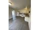 Bright kitchen with white appliances and cabinetry, vinyl flooring at 915 Major Ave, Henderson, NV 89015