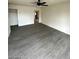 Bright living room featuring gray vinyl flooring and ceiling fan at 915 Major Ave, Henderson, NV 89015