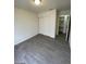 Bedroom with grey wood-look flooring and built-in shelving at 915 Major Ave, Henderson, NV 89015