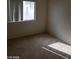 Simple bedroom with carpet flooring and a window at 1023 Sunny Acres Ave, North Las Vegas, NV 89081