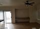 Living room with tile floors, sliding door, and built-in shelving at 1023 Sunny Acres Ave, North Las Vegas, NV 89081