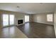 Living room with hardwood floors, fireplace, and backyard access at 9312 Angelfish Dr, Las Vegas, NV 89117