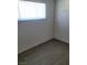 Simple bedroom with gray flooring and a window at 424 Stanford St, Las Vegas, NV 89107