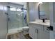 Modern bathroom with marble shower and white vanity at 2881 Thunder Bay Ave, Henderson, NV 89052