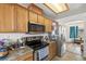 Close-up view of the kitchen's stainless steel appliances and oak cabinetry at 1510 Princeton Cir, Pahrump, NV 89060