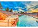 Stunning pool with a waterfall and built-in seating at 915 Calville Estates Ct, Henderson, NV 89015