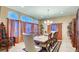 Elegant dining room with large table, chandelier, and rich decor at 520 Swallow Cv, Boulder City, NV 89005