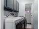 Laundry room with washer, dryer, and upper cabinets at 2100 Las Flores St, Las Vegas, NV 89102