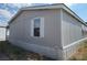 Gray manufactured home with white shutters and carport at 41 W Zapata Dr, Pahrump, NV 89048