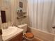 Bathroom with tub and shower, wood toilet seat, and shelves at 41 W Zapata Dr, Pahrump, NV 89048