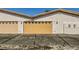 Two-car garage with tan doors and asphalt driveway at 250 Big Horn Dr, Boulder City, NV 89005