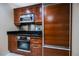 Modern kitchen with stainless steel appliances and dark wood cabinetry at 125 E Harmon Ave # 414, Las Vegas, NV 89109