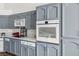 Well-equipped kitchen with grey cabinets and quartz counters at 3241 E Winery Rd, Pahrump, NV 89048